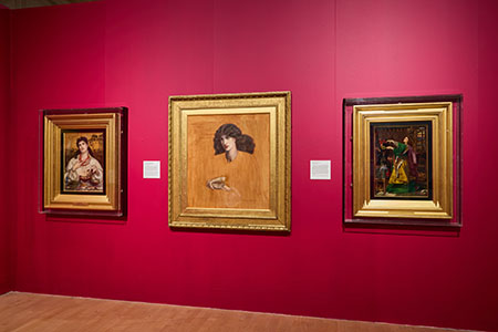 3 pre raphaelite images against a red wall